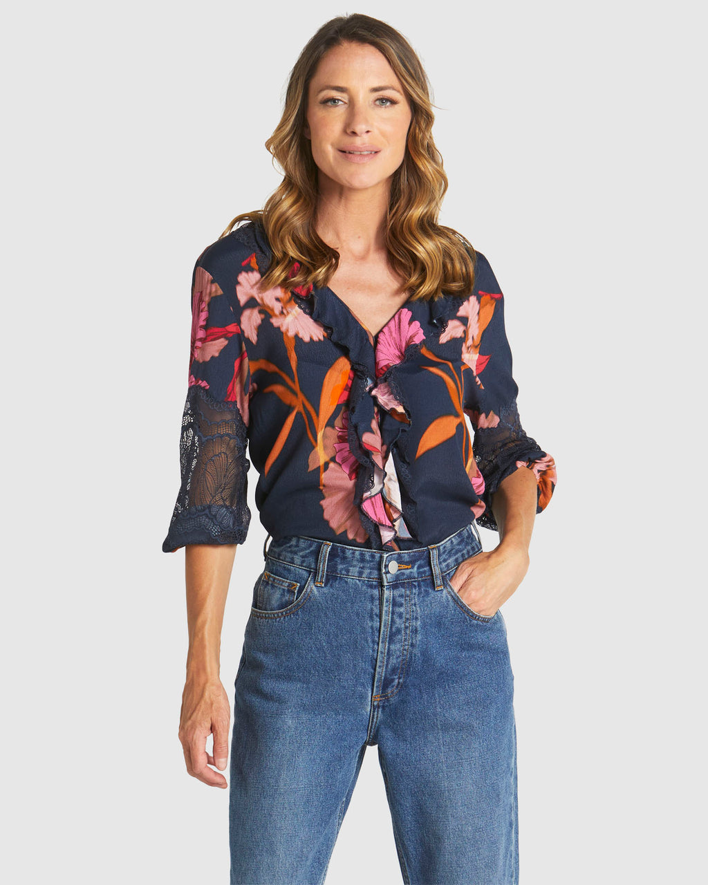Woman wearing a floral blouse and blue jeans on a white background
Captivation Shirt Navy Floral