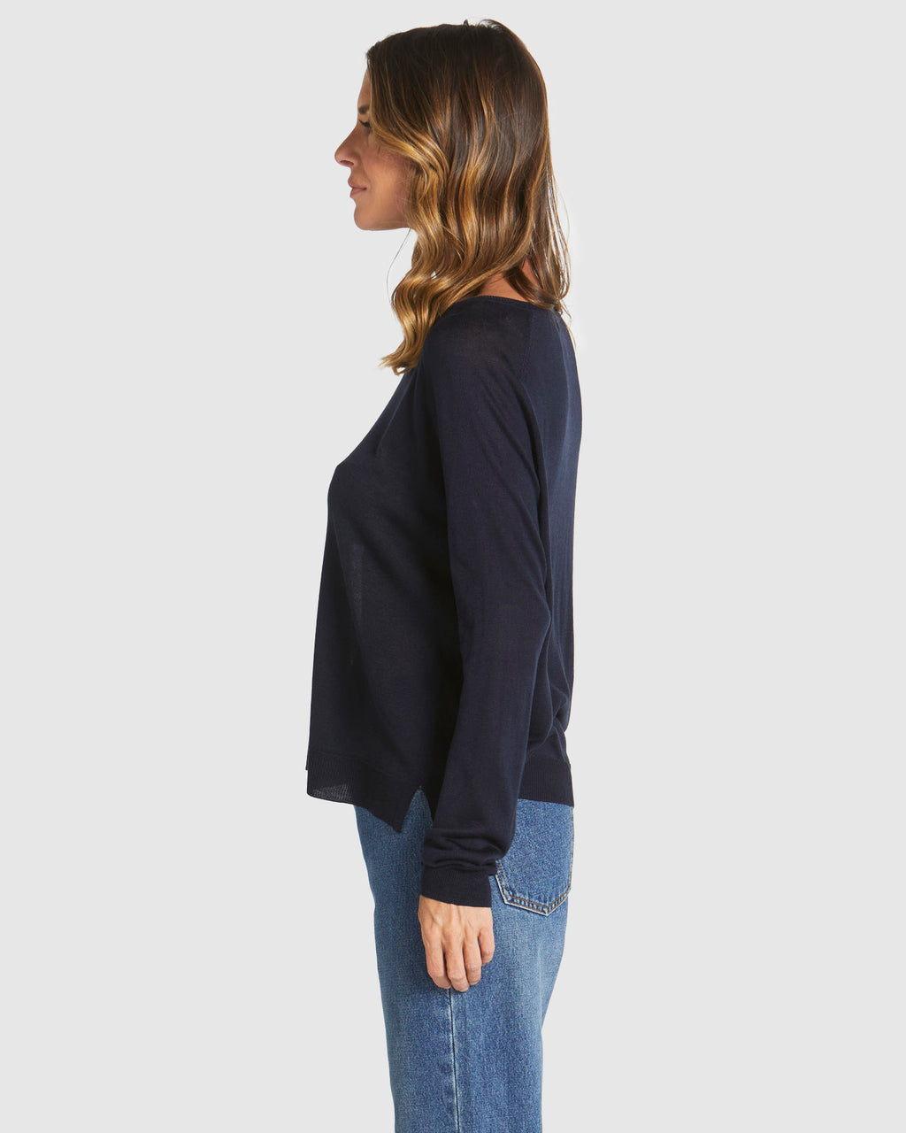 Woman wearing a navy sweater and blue jeans on a white background
Reminiscent Knit Navy
