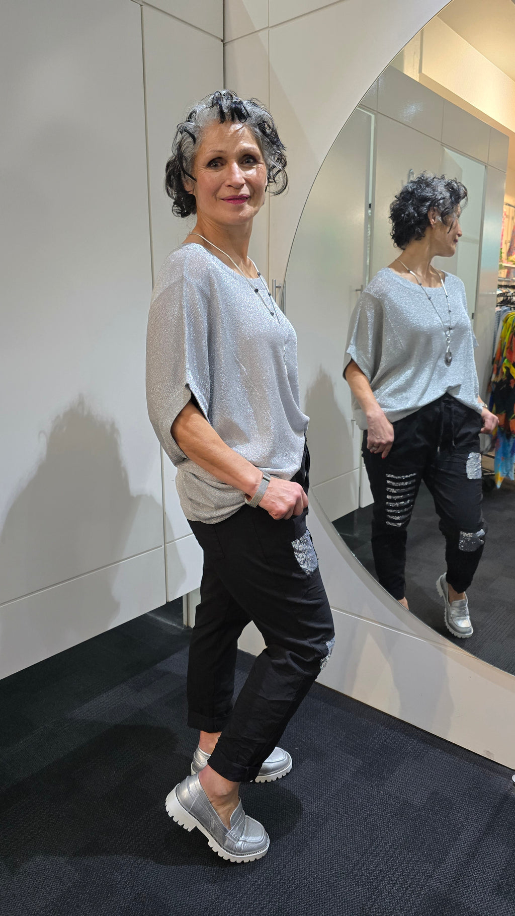 Woman in a gray oversized shirt and black ripped jeans standing in front of a mirror.
Italian Seq Pants Black