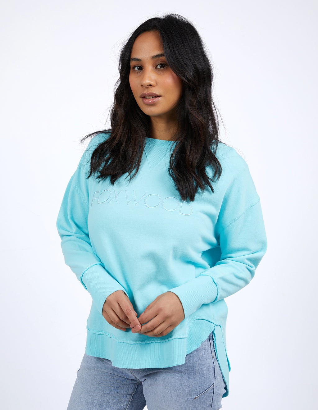 Woman wearing a light blue sweatshirt and light gray pants on a white background
Simplified Crew Light Blue