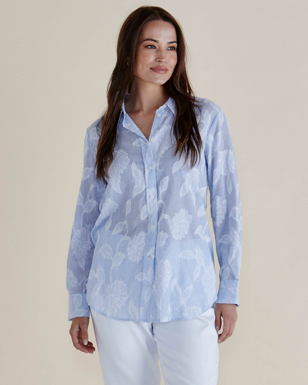 Woman wearing a light blue patterned shirt and white pants against a beige background
Lace Stripe Shirt Blue