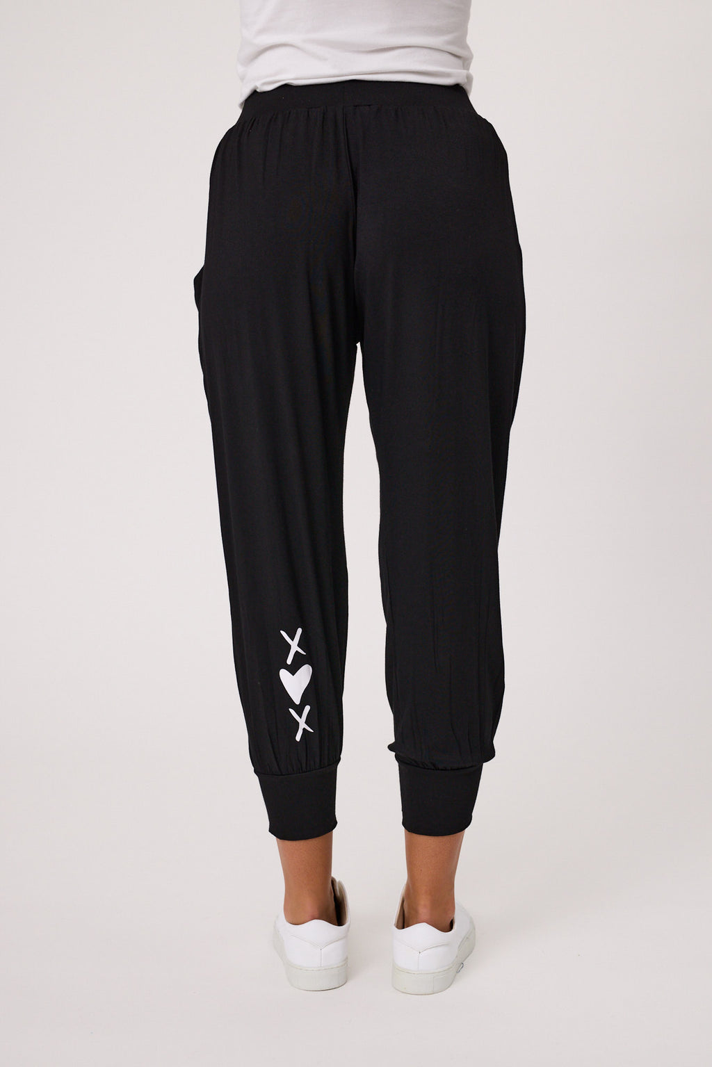 Person wearing black harem pants and white sneakers on a plain background Signature Print Fresco Pant Black