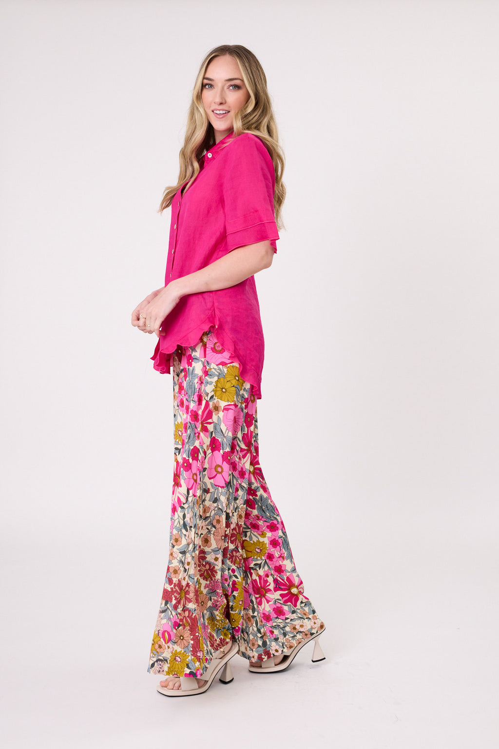 Woman wearing a bright pink shirt and floral pants on a white background
Camilla Linen Top Fuchsia