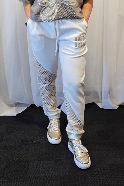 Person wearing a gray t-shirt with a decorative design and light blue pants against a white curtain background.
Italian Relaxed Lounge Pants White