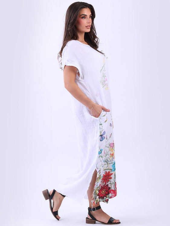 Woman wearing a white dress with colorful floral pattern on a white background
Garden Print Slouch Dress White