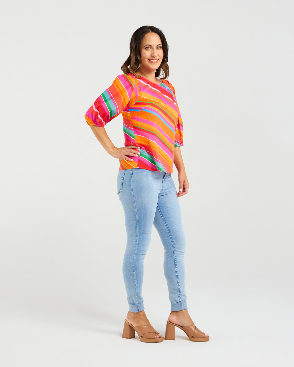 Woman wearing a colorful striped shirt and light blue jeans on a white background
Willow Top Dynamic Stripe