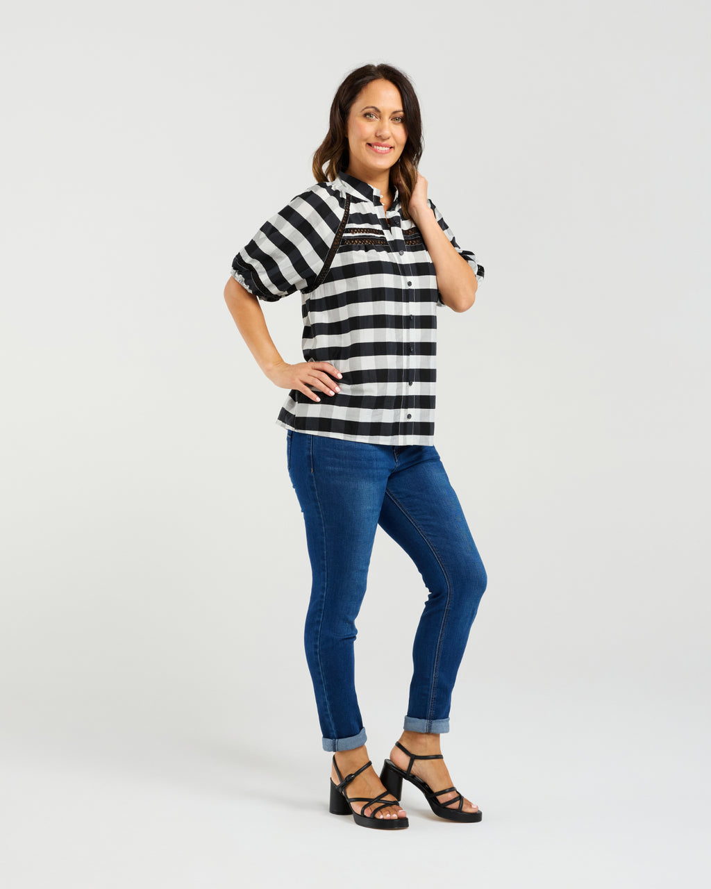 Woman wearing a black and white striped shirt and blue jeans on a white background
Penelope Blouse Black Check