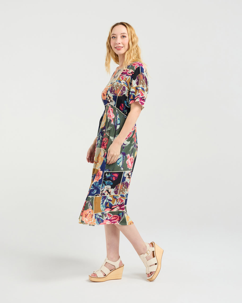 Woman wearing a colorful floral dress on a white background
Myla Dress Flower Party