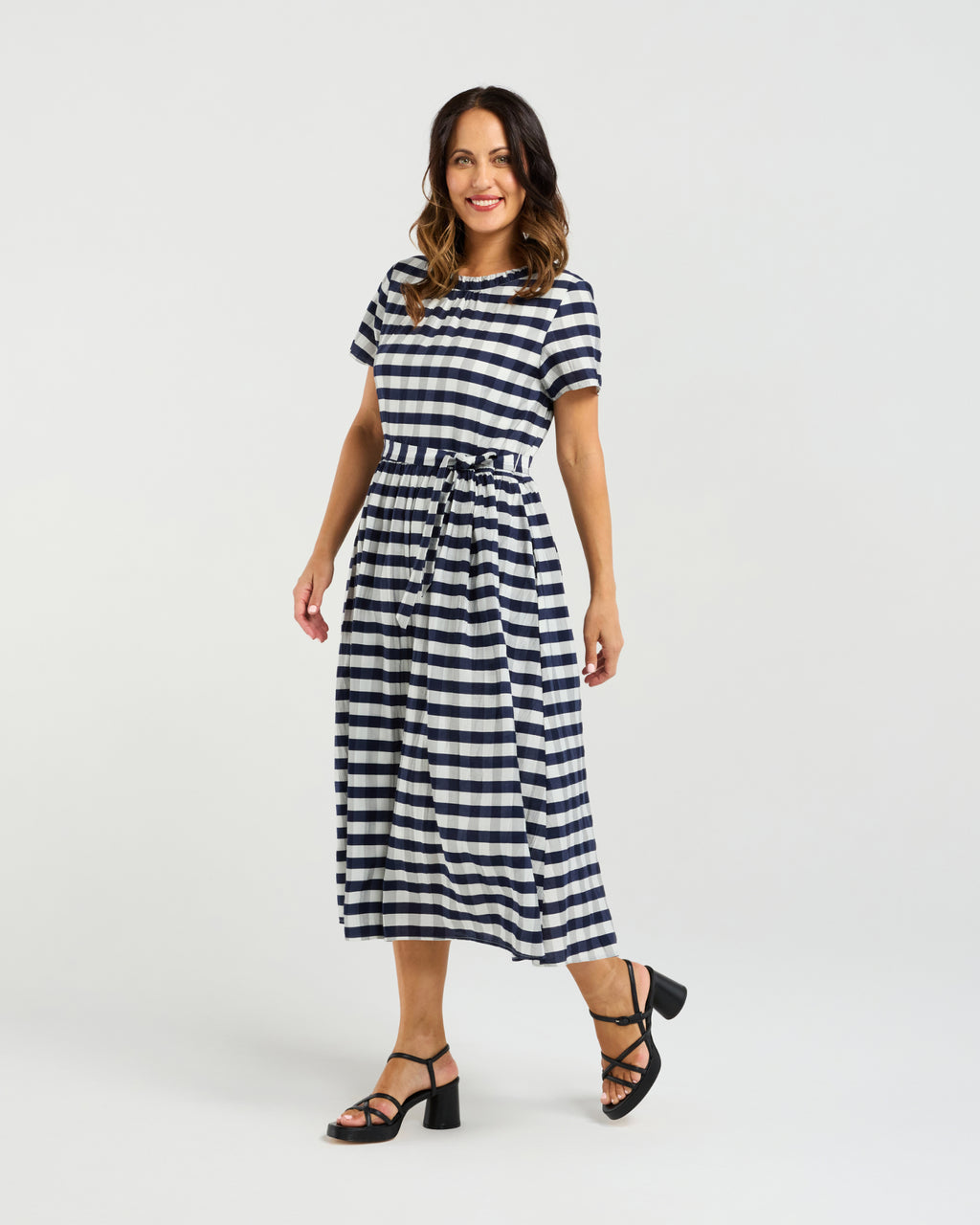 Woman wearing a black and white striped dress on a white background
Scarlett Dress Navy Check