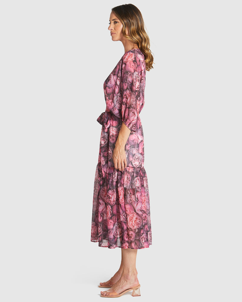 Woman wearing a pink floral dress on a white background