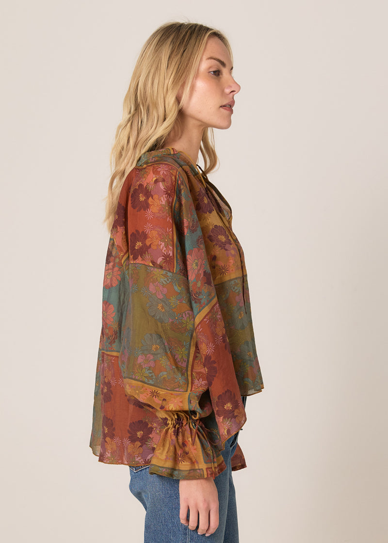 Woman wearing a patterned blouse with a neutral background
Bohemian Top Nouveau Floral Green