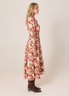 Woman wearing a floral dress on a plain background