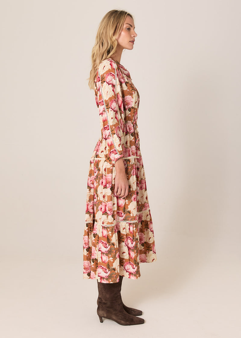 Woman wearing a floral dress on a plain background