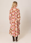 Woman wearing a floral dress with a neutral background