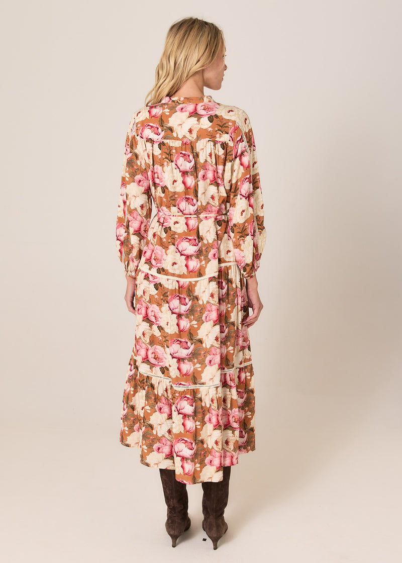 Woman wearing a floral dress with a neutral background