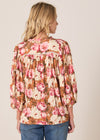 Woman wearing a floral blouse with a beige background
Sweet Emotion Top Garden Pink
