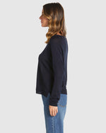 Woman wearing a black long-sleeve top and blue jeans on a white background
Reminiscent Knit Navy