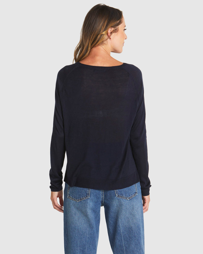 Person wearing a black long-sleeve top and blue jeans on a white background
Reminiscent Knit Navy