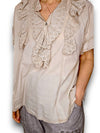 Beige blouse with lace details worn by a person on a white background
Eyelet Top Pale Beige