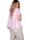 Woman wearing a light pink blouse and beige pants on a white background
Eyelet Top Bubblegum Pink