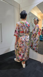 Two people wearing floral outfits standing in a kitchen. Round Neck Dress Multi