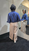 Person wearing a blue jacket and beige pants standing in front of a mirror. Saffra Relax Leg Jean Pink