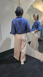 Person wearing a blue jacket and beige pants standing in front of a mirror. Saffra Relax Leg Jean Pink