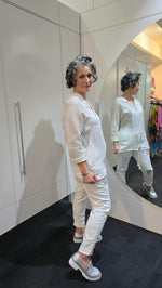Person wearing a white outfit with a textured pattern, standing in front of a mirror.
Italian Seq Pants White