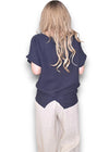 Person wearing a navy blue top and light-colored pants on a white background Split Back River Tee Navy