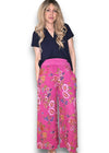Woman wearing a navy top and pink floral pants on a white background Palazzo Doily Rose Pant Hot Pink
