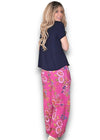 Woman wearing a navy top and pink floral pants on a white background Palazzo Doily Rose Pant Hot Pink