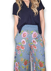 Woman wearing a navy top and floral pants on a white background Palazzo Doily Rose Pant Petrol