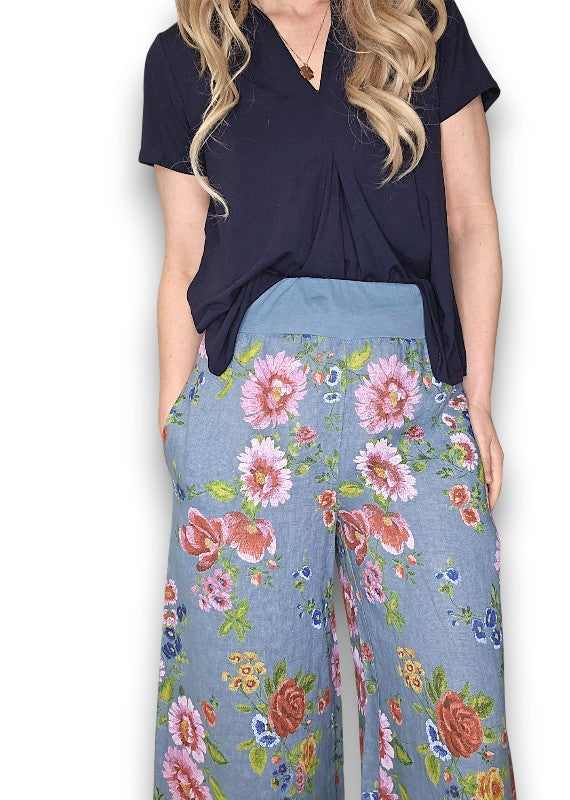 Woman wearing a navy top and floral pants on a white background Palazzo Doily Rose Pant Petrol
