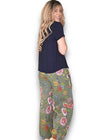 Woman wearing a navy top and floral pants on a white background Palazzo Doily Rose Pant Forest