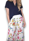 Woman wearing a navy top and floral white pants on a white background Palazzo Doily Rose Pant White