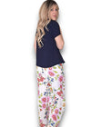 Woman wearing a navy top and floral pants on a white background Palazzo Doily Rose Pant White