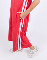 Red tracksuit with white stripes worn by a person on a light gray background
Recovery Dress Red