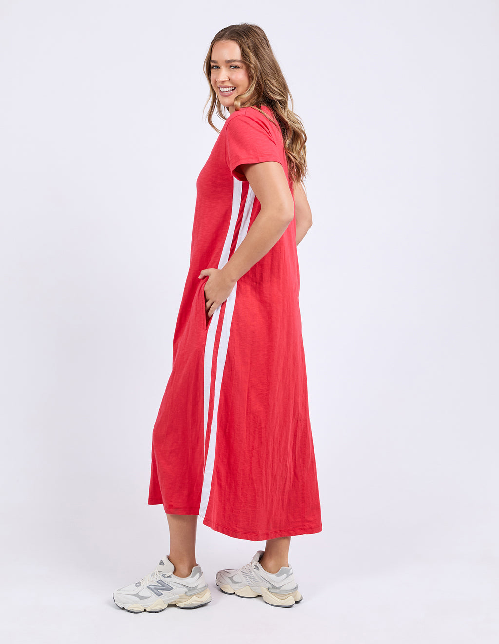 Woman wearing a red dress with white stripes on a white background
Recovery Dress Red