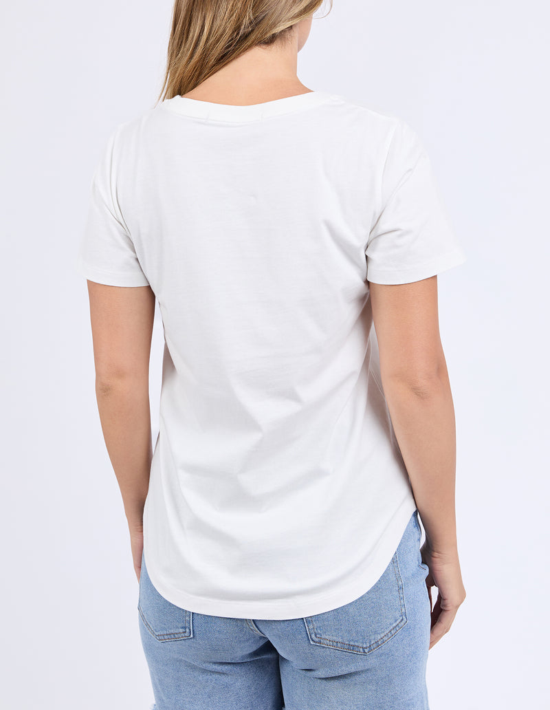 Person wearing a plain white t-shirt and blue jeans on a light gray background
Limoncello Tee Vintage White
