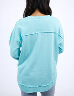 Light blue long-sleeve top worn by a person on a white background
Simplified Crew Light Blue