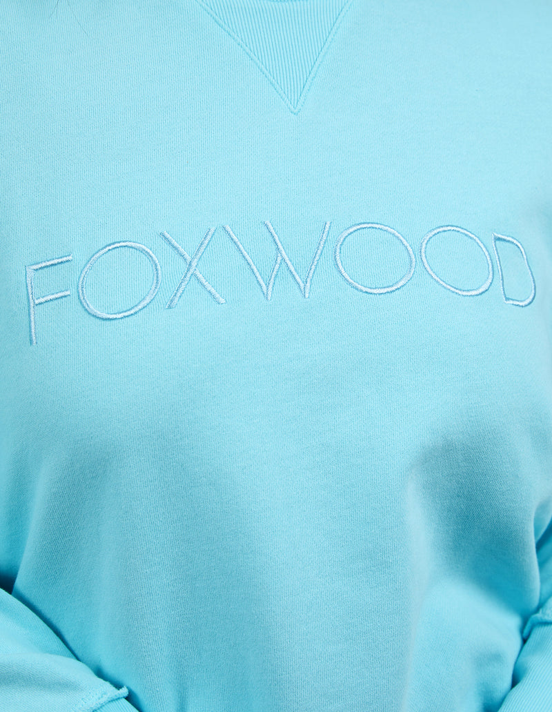 Light blue sweatshirt with 'FOXWOOD' branding on a light blue background
Simplified Crew Light Blue