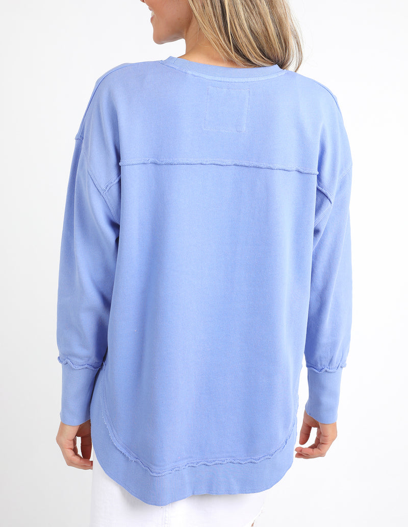 Light blue sweatshirt worn by a person on a white background
Simplified Crew Neon Blue