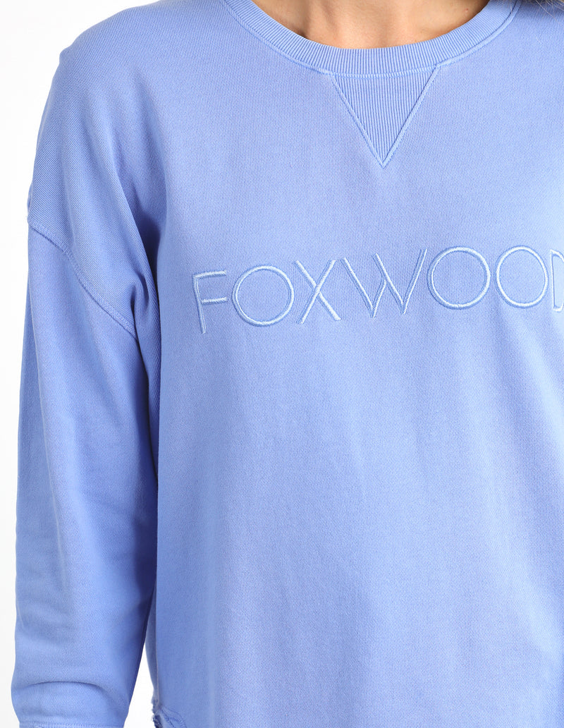 Light blue sweatshirt with 'FOXWOOD' text on a plain background
Simplified Crew Neon Blue