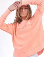 Woman wearing a peach-colored sweatshirt with 'FOXWOOD' embroidery on a white background
Simplified Crew Neon Peach