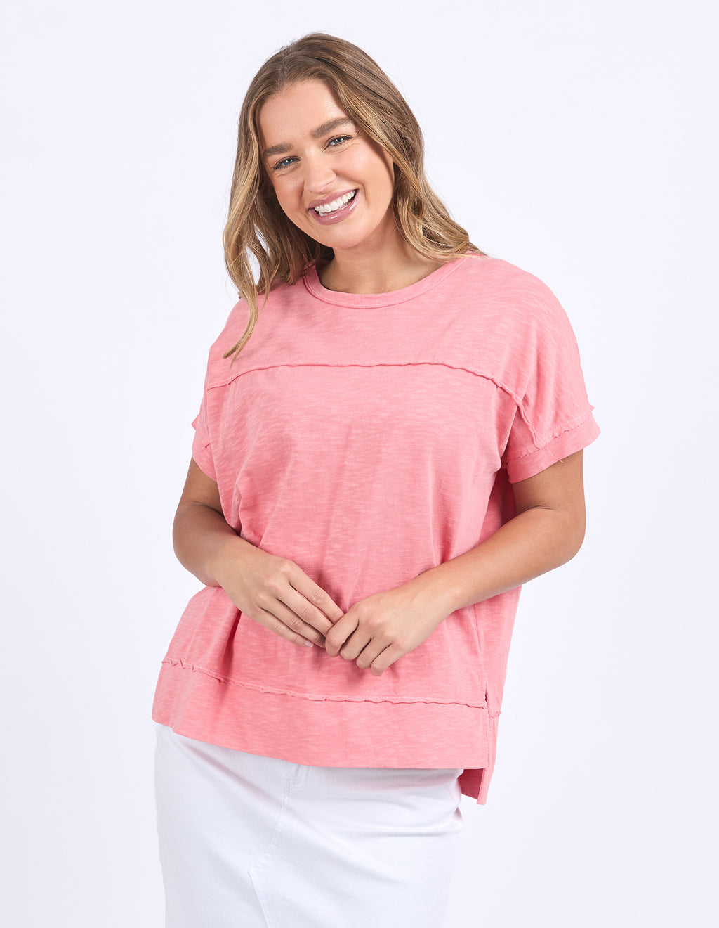 Woman wearing a pink top on a white background
Allison Tee Rose