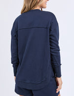 Navy blue long-sleeve top worn by a person on a light purple background
Simplified Confetti Crew Navy