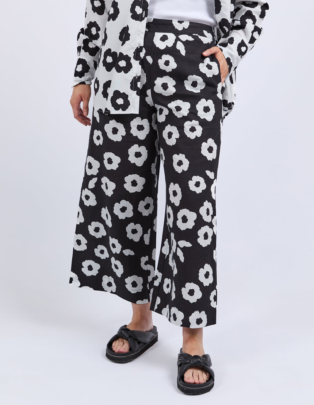 Person wearing black floral-patterned pants on a white background
Azalea Pants Navy