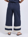 Navy blue wide-leg pants with white stripes worn by a person on a white background
Scarlet Pants Navy