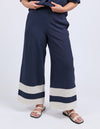 Navy blue pants with white stripes worn by a person on a white background
Scarlet Pants Navy