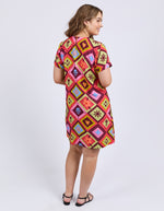 Woman wearing a colorful patterned dress on a white background
Rhode Dress Geo Print